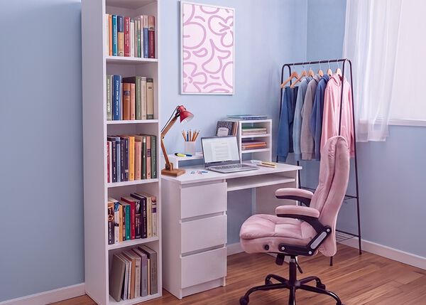 Modern studieplats f&ouml;r studenter med vitt skrivbord, ergonomisk kontorsstol, laptop, bokhylla, f&ouml;rvaringsm&ouml;bel och kl&auml;dst&auml;llning i ett ljust och organiserat sovrum f&ouml;r bekv&auml;ma studier och vardagsliv.