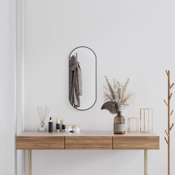 vidaXL Väggspegel svart 70x30 cm oval